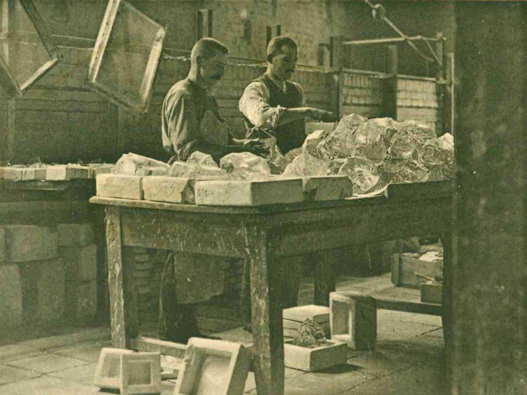 Einlegen des optischen Rohglases in die Senkformen (Foto: SCHOTT Archiv).