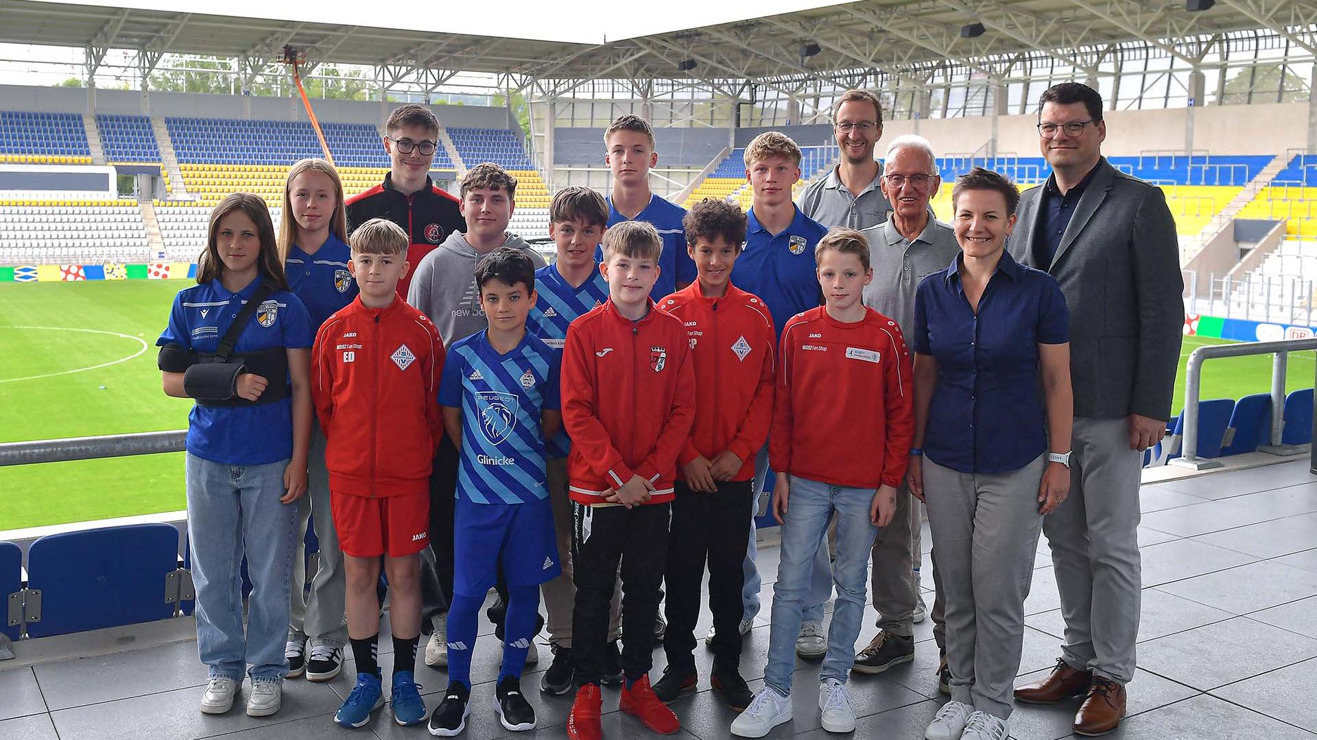 Nachwuchsfußballerinen und Nachwuchsfußballer stehen für ein Gruppenfoto im Ernst-Abbe-Sportfeld in Jena