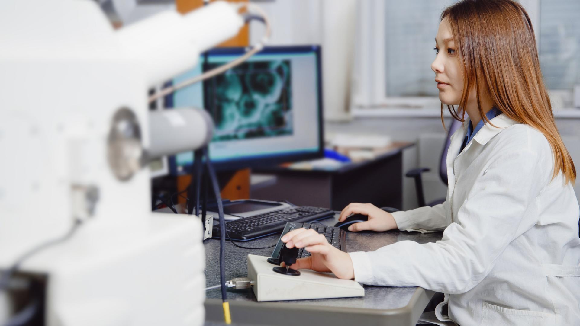 Eine Wissenschaftlerin bedient Forschungsinstrumente im Labor