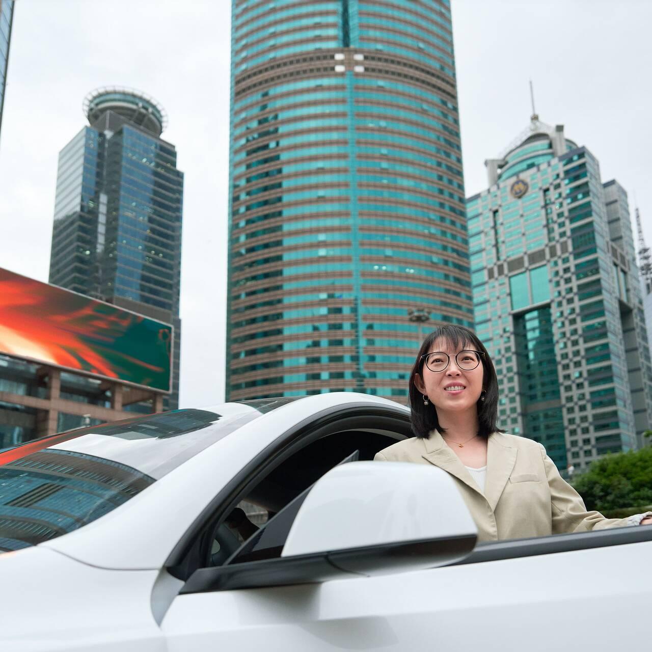 Yuqing Bai vor ihrem Auto in Shanghai