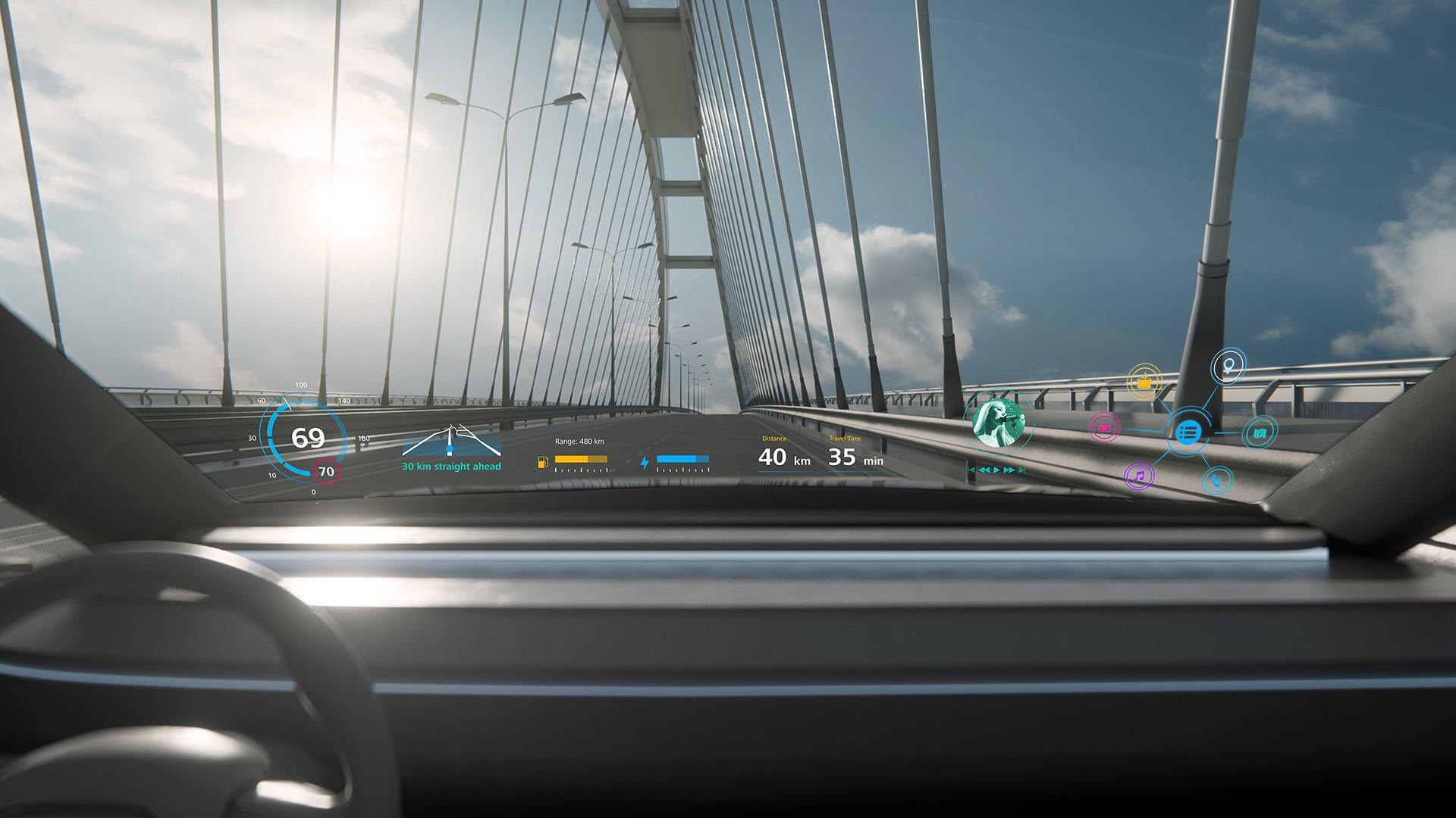 Der Blick aus dem Auto heraus zeigt Abbildungen verschiedener technischer Funktionen des Fahrzeugs auf die Windschutzscheibe projiziert