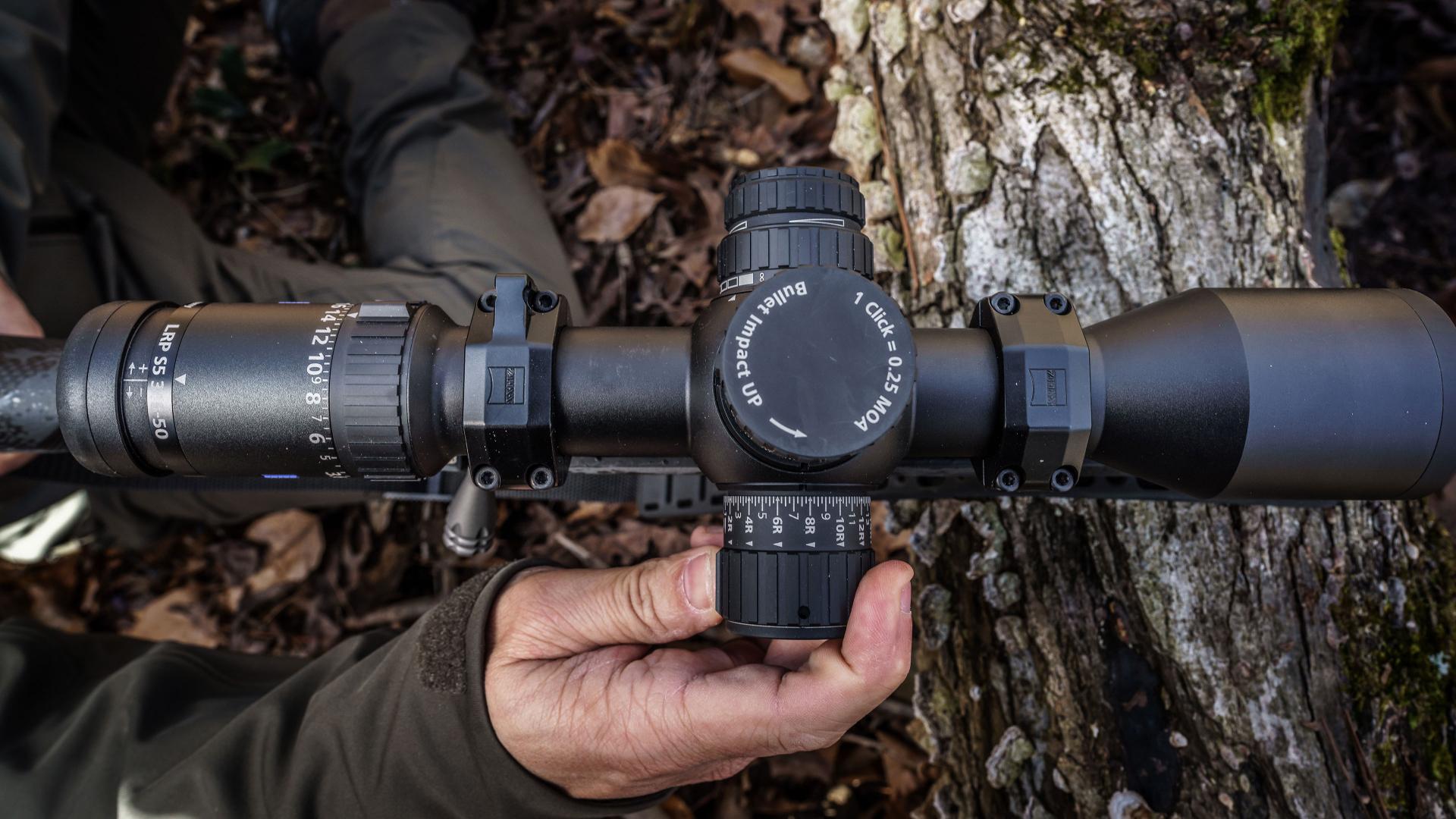 Hands adjusting ZEISS LRP S5 riflescope turrets, highlighting precise and repeatable tactile adjustments
