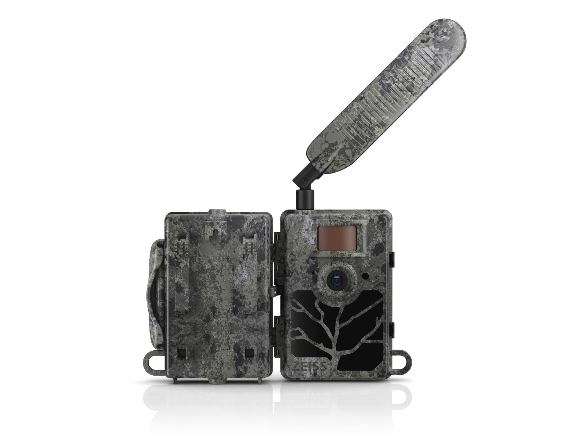 Camouflaged ZEISS trail camera with an open casing and extended antenna, featuring a lens and display on the front.