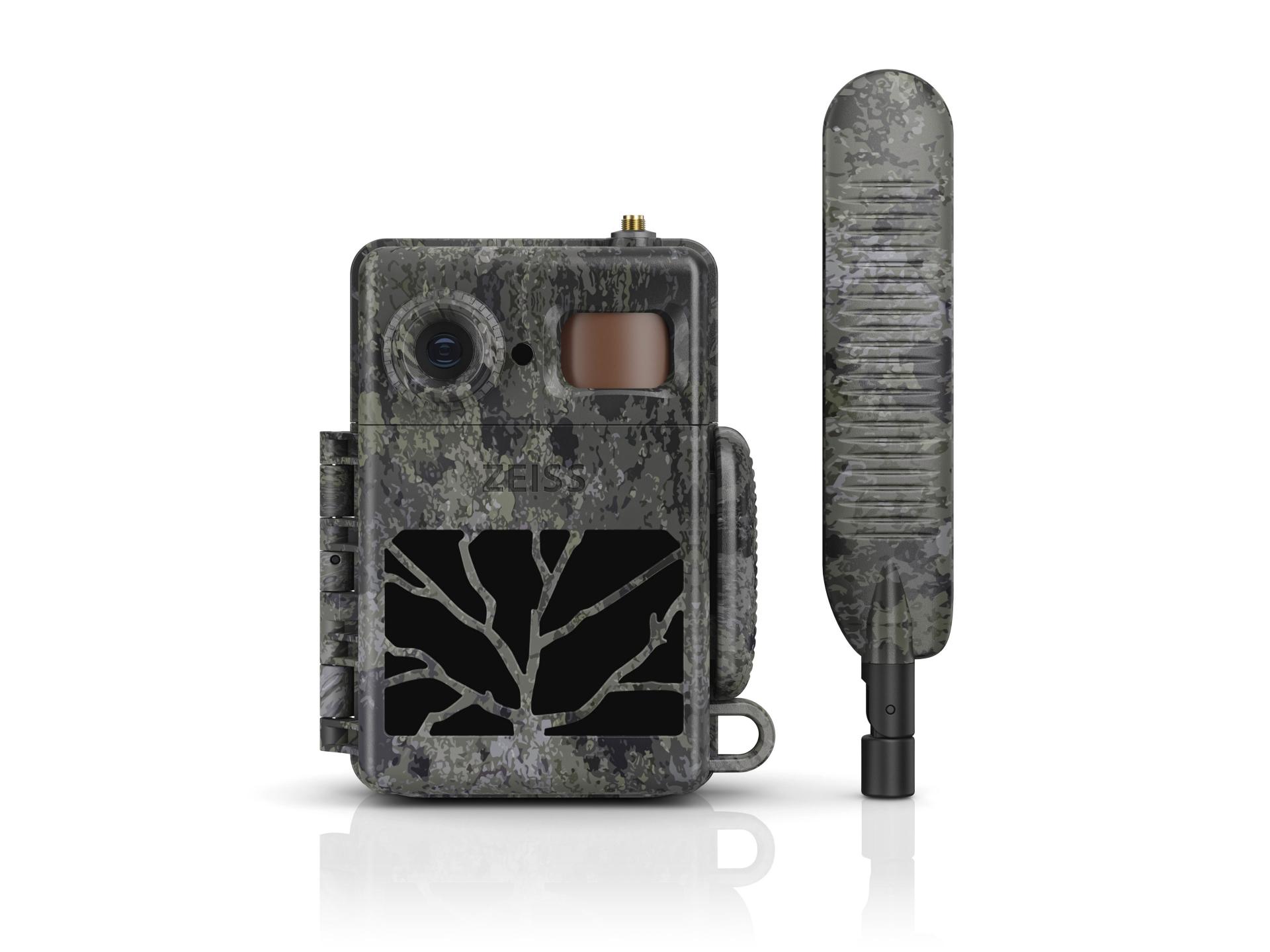Camouflaged ZEISS trail camera with a detachable antenna, featuring a rugged design and a tree-branch pattern on the front.
