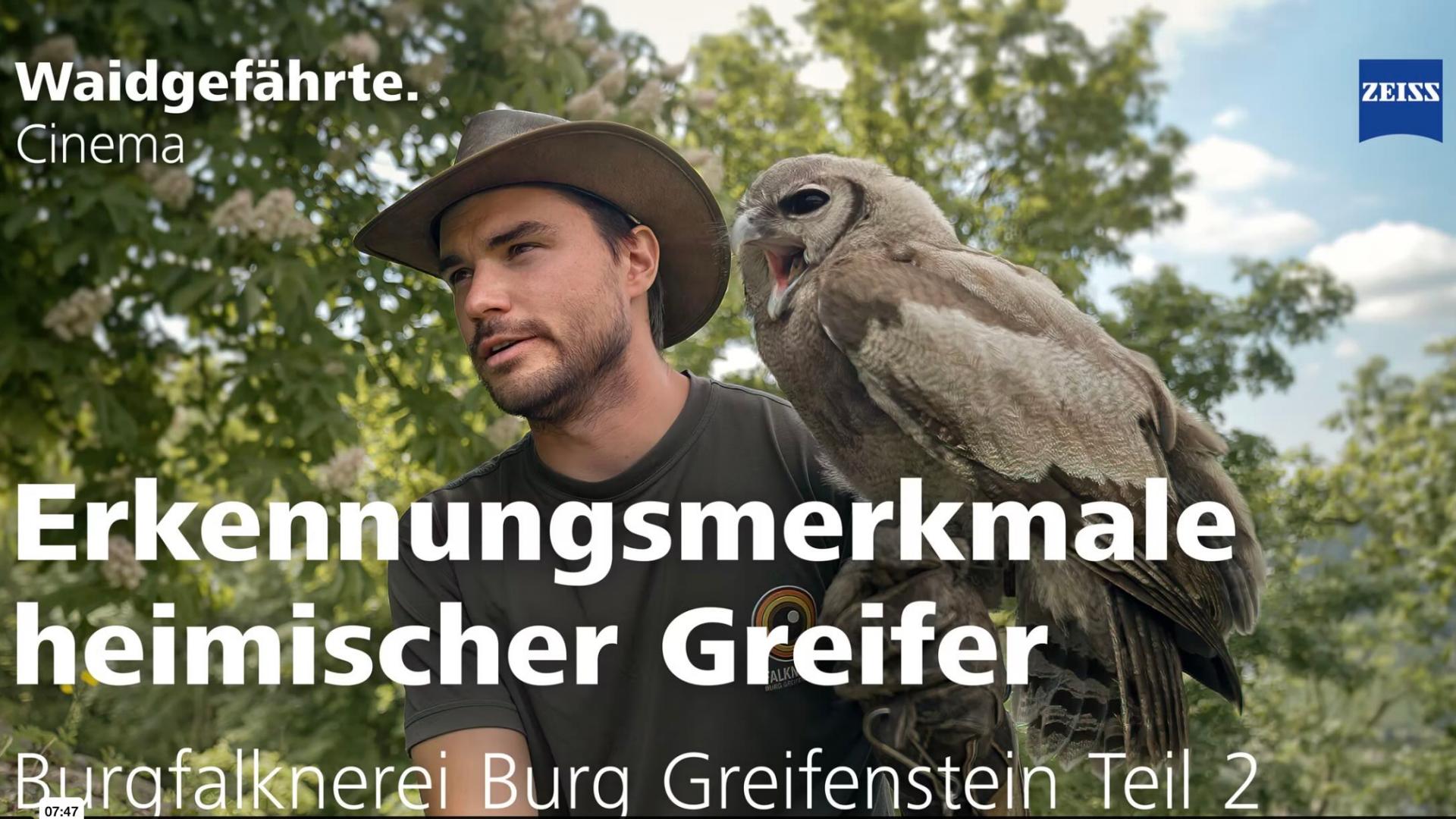 Ein Falkner mit Hut hält einen heimischen Greifvogel auf dem Arm und erklärt dessen Merkmale, präsentiert von ZEISS.