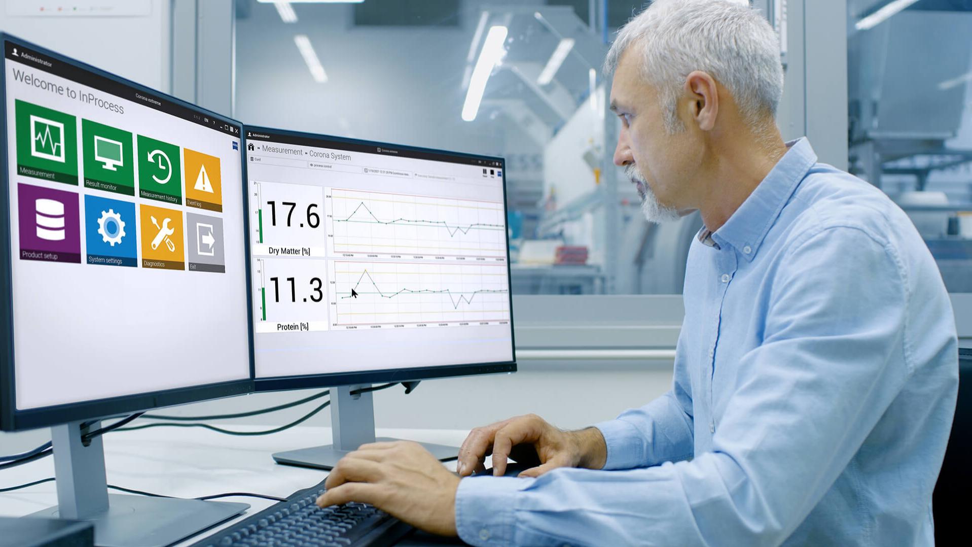 engineer sits in front of the computer in a production environment in his office, the screens show the interface of the inprocess software 