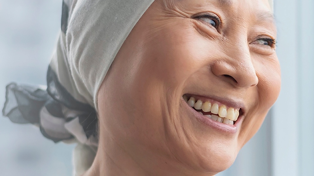 Hoffnung gegen Brustkrebs Lachende Frau mit Kopftuch
